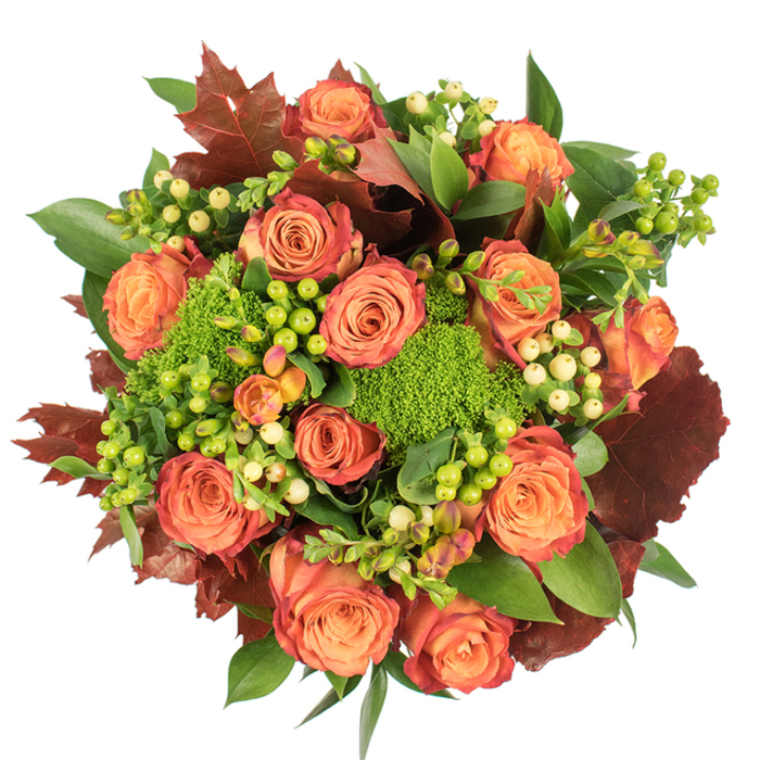 Viewed straight down against a plain white surface, this richly textured autumn bouquet is composed with the eye of a neighbourhood florist who knows Willesden's tonal weather. A close-packed circle of large roses forms the visual nucleus, petals moving from warm peach and coral at the centers to saturated orange and russet at the outer edges, some petals tipped in a reddish-rust that gives a subtle ombré effect reminiscent of tree leaves in early November. Nestled among these classic blooms are tight clusters of hypericum berries, some in a bright, zesty lime and others in a soft creamy yellow, their small, glossy spheres creating delicate highlights and a tactile contrast to the roses' velvety faces. Intervening the floral masses are several rounded clusters of Green Trick dianthus - green, cushiony, and slightly shaggy - contributing an unusual, mosslike texture that makes the arrangement feel both modern and woodland-inspired. Deeply coloured lobed leaves with a dry, burnished look are scattered through the design to add weight and a seasonal note; broader, glossy green foliage fills and lifts the bouquet, ensuring a lush, abundant silhouette. The lighting reads soft and even, producing gentle shadows that reveal the bouquet's layered depth and invite a hand to linger on its varied textures. This piece speaks of harvest tables and warm gatherings, a seasonal centrepiece suitable for friends meeting after a stroll around Willesden Market or a quiet supper near Chamberlayne Road. It brings together scent, colour, and touch in an arrangement that feels both carefully curated and simply honest.